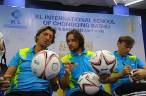 Soccer stars Marek Jankulovski, Dario Simic and Dimas Texeira sign soccer balls for the students.