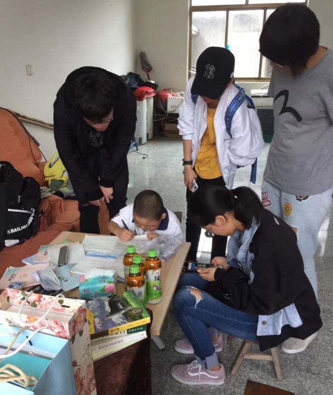 Students visiting with special needs child and his family