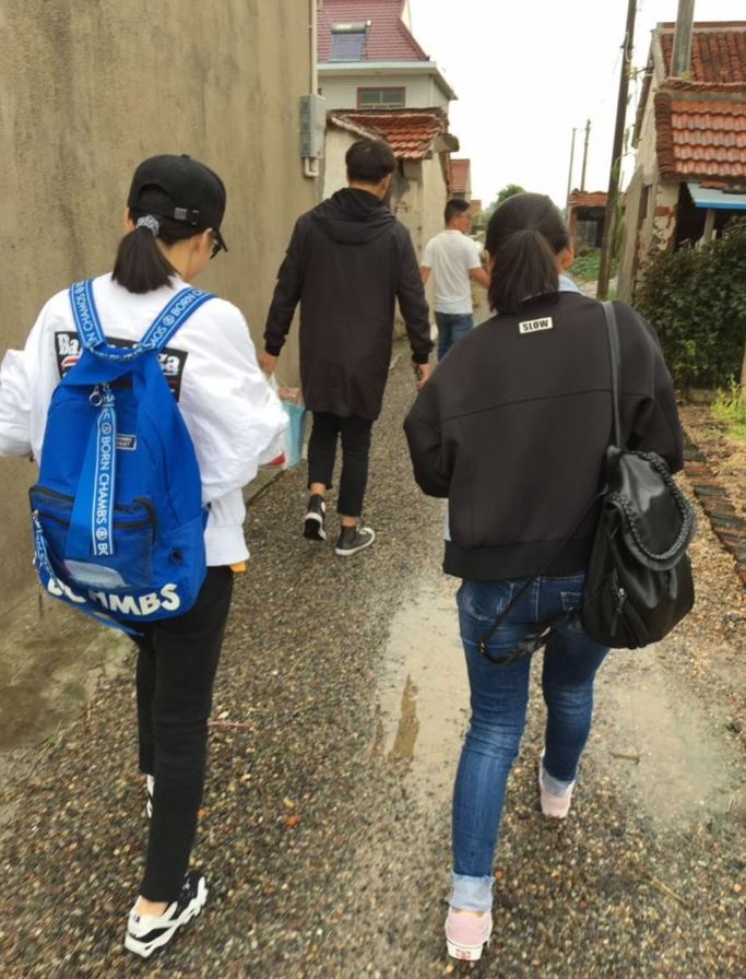 Students on their way to visit a needy child in the community