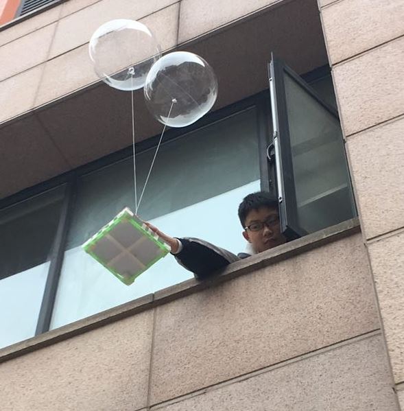 Wuhan student releasing egg drop container from campus window