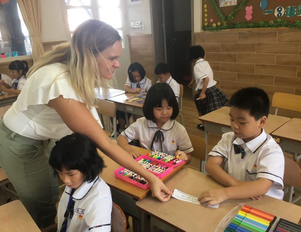 Ms. Hilt helping her students with a classroom project