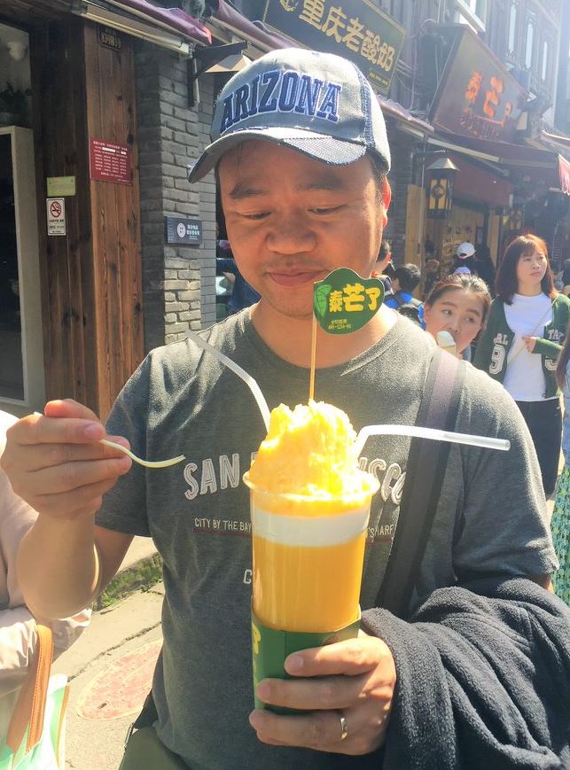 Tasting a mango ice shake in Ciqikou Ancient Chongqing