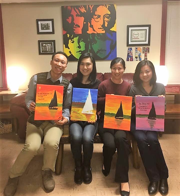 Online Director painting with KL staff members